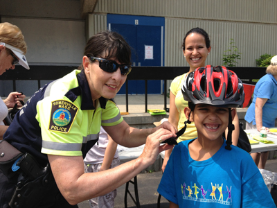 Somerville police officer and child at Bike Safety Day 