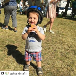 child wearing a bicycle helmet at the Ashland Farmers Market