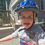 Child riding a bicycle and wearing a bicycle helmet in Tewksbury, Massachusetts