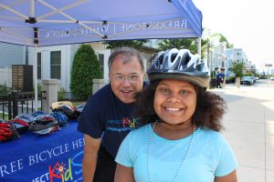 Attorney David White with a young cyclist in South Boston.