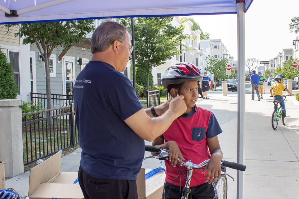 A boy receiving a new bicycle helmet.