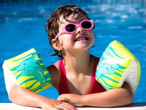 little girl swimming in pool