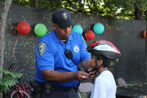 Cambridge police officer fitting bike helmets