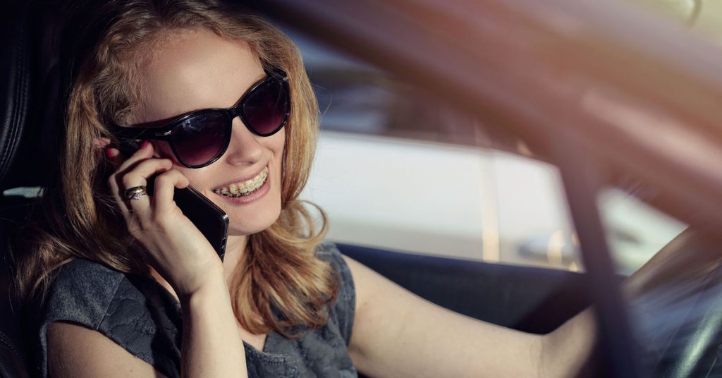 Woman talking on cell phone in car