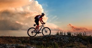 man riding bicycle in mountains