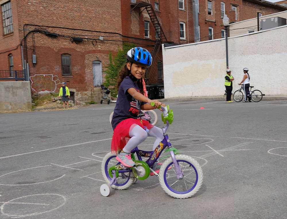 A child wearing a Project KidSafe helmet at the Lawrence Ciclovia.