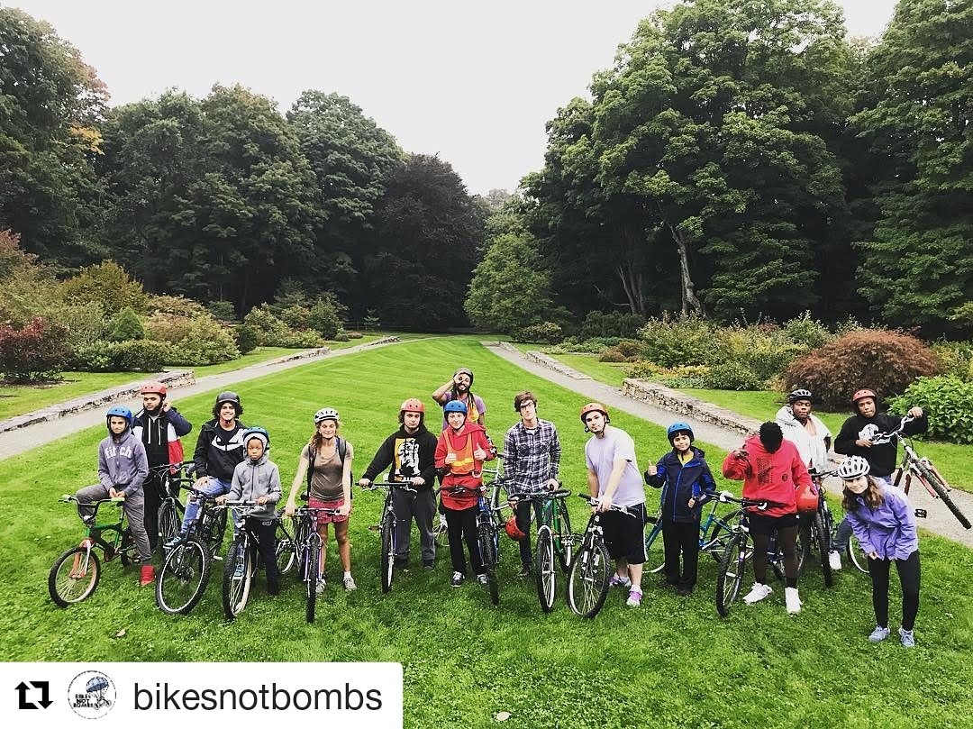 Bikes Not Bombs' Earn-a-Bike Class Wearing Bicycle Helmets donated by the Boston personal injury lawyers at Breakstone, White & Gluck