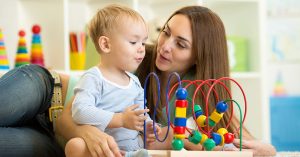 Mother playing with child and toy