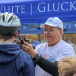 Attorney David W. White fitting helmets at Framingham Earth Day 2019. Part of Breakstone, White & Gluck's Project KidSafe campaign to prevent head injuries.