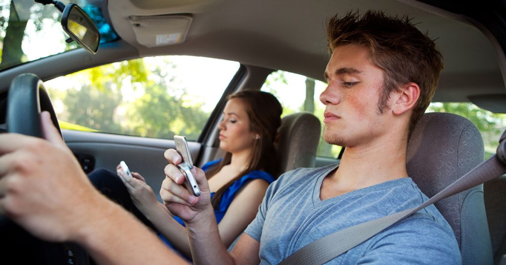 Teen driver using cell phone behind the wheel