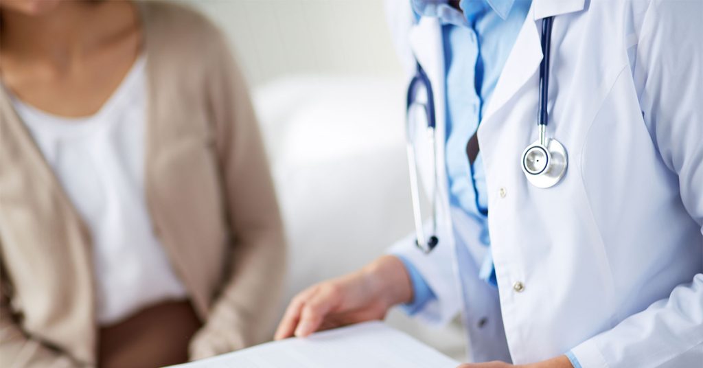Doctor with a patient at a Boston hospital.