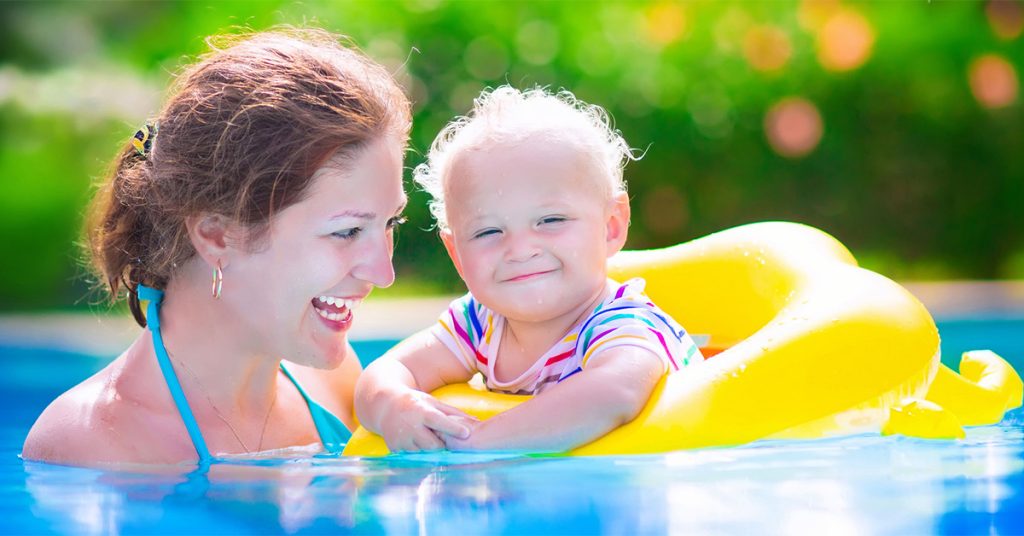 Mother and child swimming safely in pool in Massachusetts.