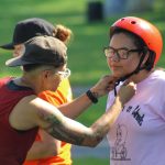 girl being fitted with a bicycle helmet at Mattapan on Wheels 2019 event.