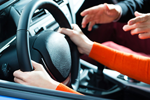 Massachusetts parent teaching a teen driver how to drive safely and defensively to prevent car accidents.