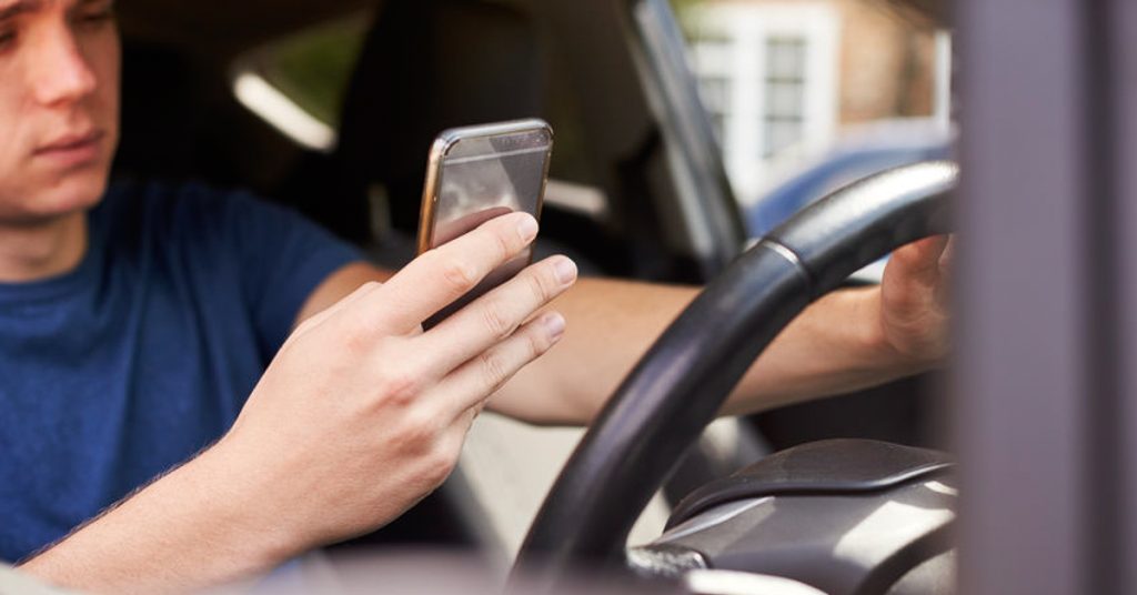 Massachusetts teen driver using cell phone, causing risk for distracted driving crash.