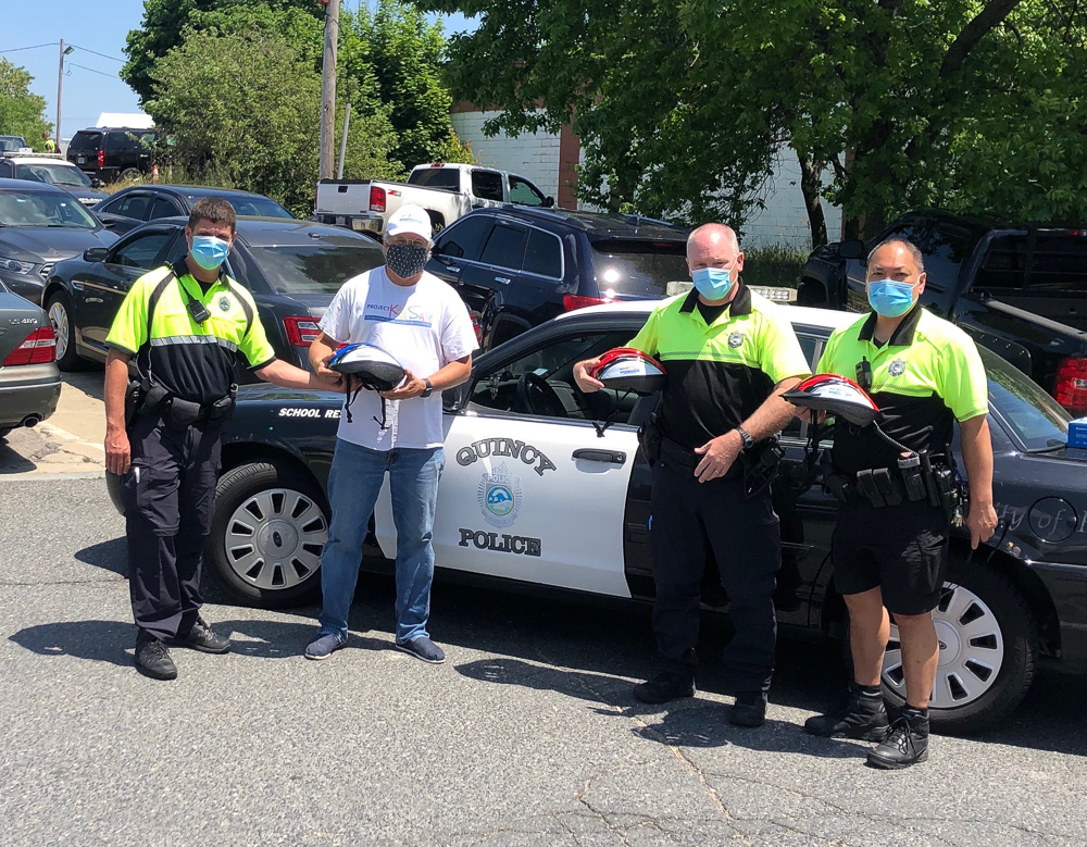 Quincy, MA Police Officers with Attorney David W. White of Breakstone, White & Gluck, which donates children's bicycle helmets to the department each year.