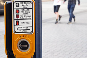 Walk signal reduces the risk of pedestrian accidents on a Boston street.