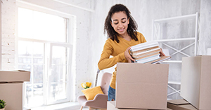 College student moving into off-campus apartment in Boston, unpacking boxes