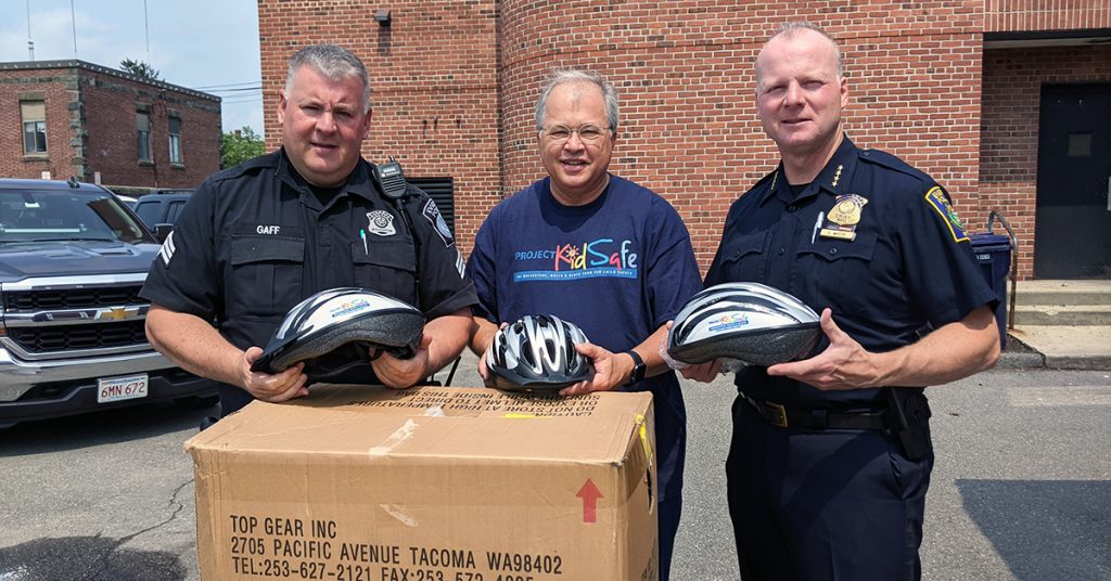 Attorney David W. White visits Everett Police to donate bicycle helmets from Breakstone, White & Gluck's Project KidSafe campaign.