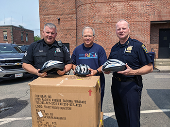 Breakstone, White & Gluck makes a donation of children's bicycle helmets to the Everett Police Department