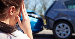 Woman suffering potential concussion symptoms after a car crash