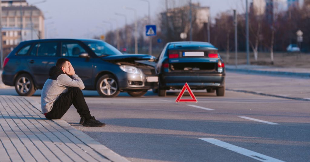 Driver sits near two-car accident scene